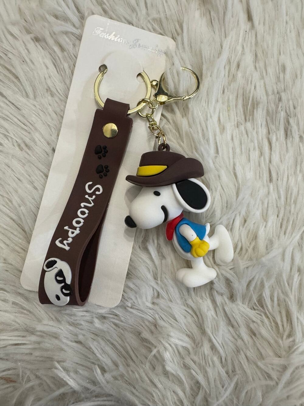 Snoopy cowboy keychain brown hat yellow band, wearing blue vest and red scarf